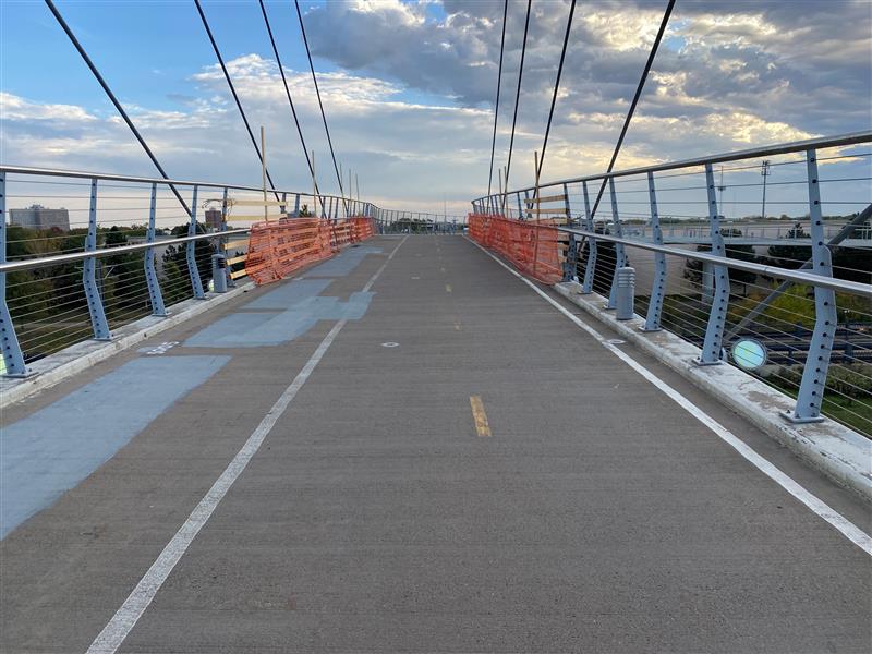 View of the paved bikeway on top of the pedestrian bridge