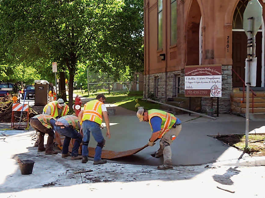 Photo of City staff upgrading pedestrian ramp