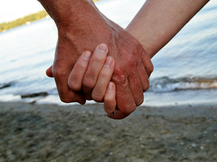 A couple holding hands.