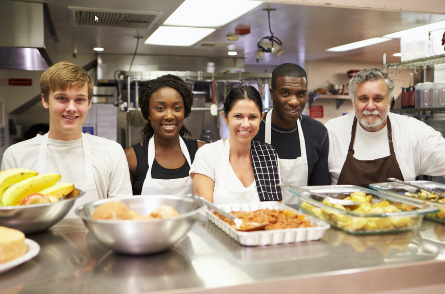 People in kitchen with food