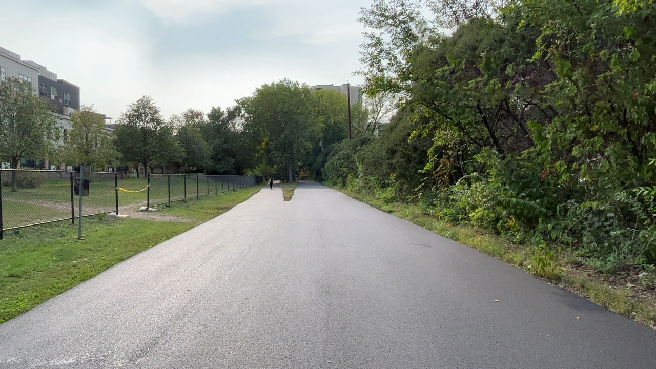 Bike and pedestrian trail from ground level, with fresh pavement