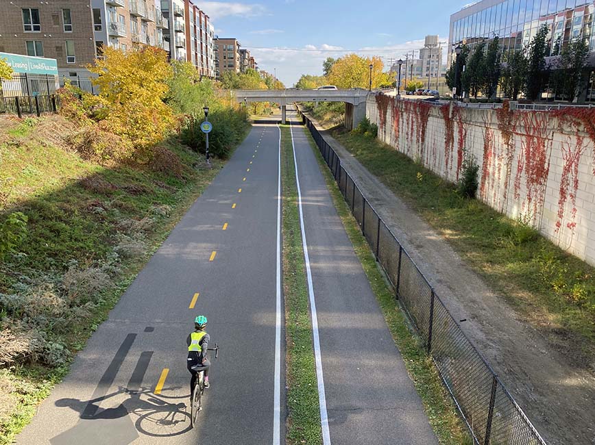 A cyclist rides along the Midtown Greenway.
