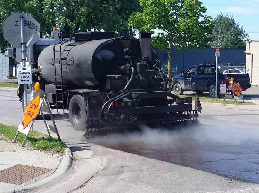 Seal coat truck working on street