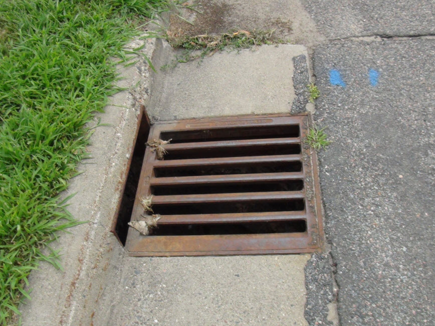 Square sewer grate along Vincent Ave. N. 