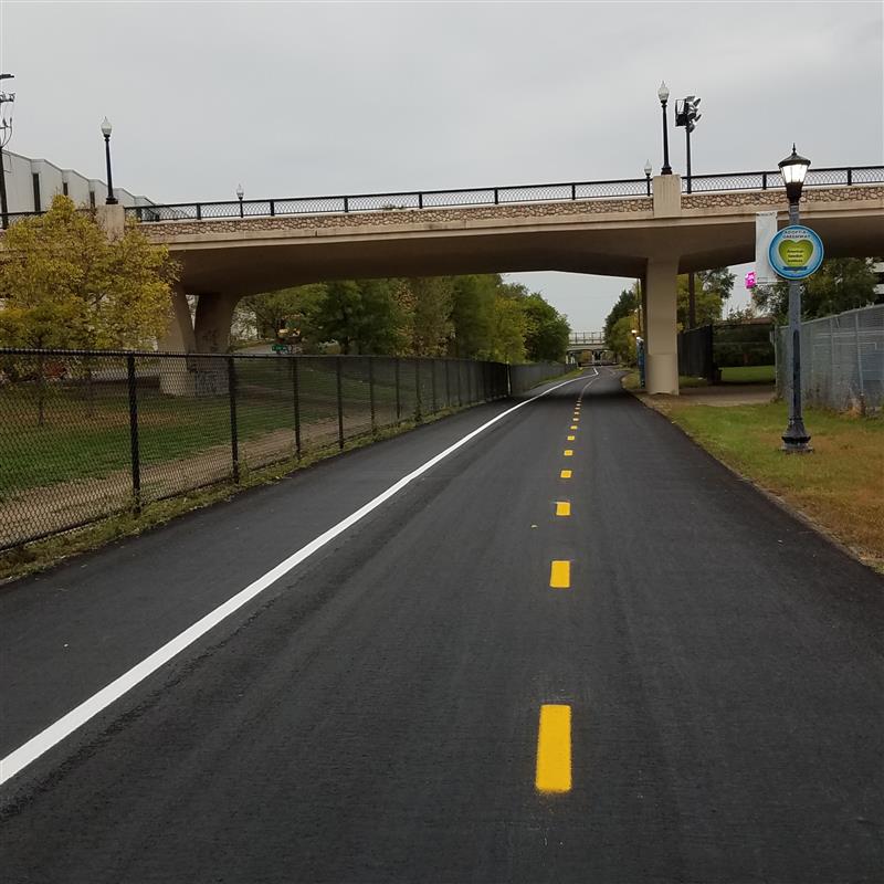 Two-way bike and pedestrian trail from ground level, with fresh pavement