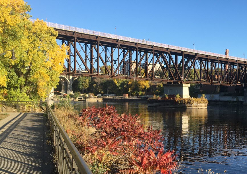 Bridge over Mississippi River surrounded by trees and a bike trail