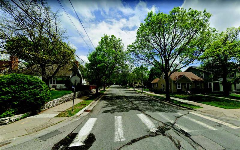 Street with centerline and bikeway striping and lined with trees