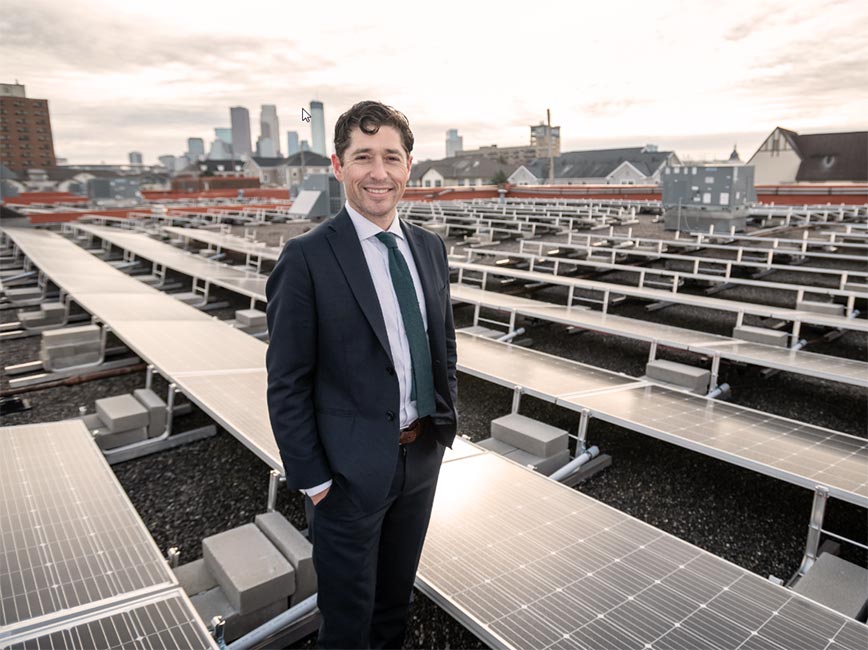 Mayor Jacob Frey by rooftop solar panels.