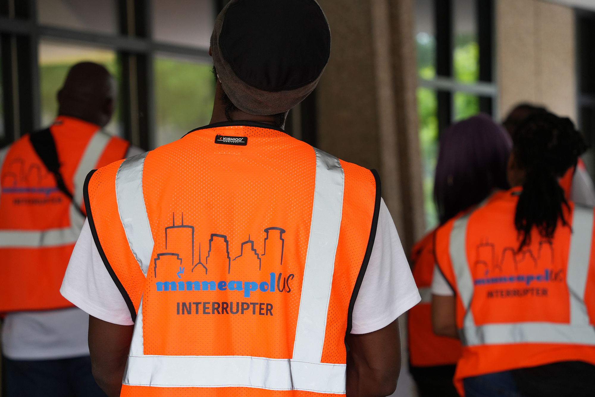 The back of a MinneapolUS violence interrupter's vest