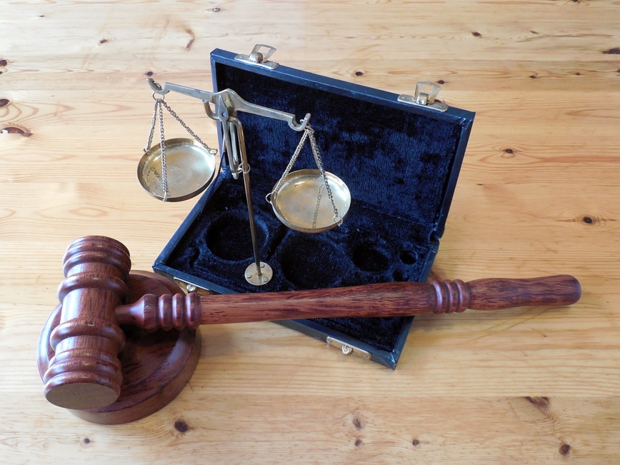 Gavel and and scales of justice on a table.