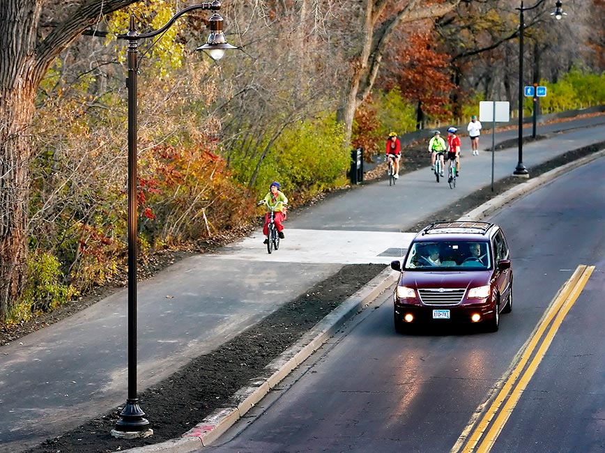 Cyclists bike down newly paved path along West River Parkway 