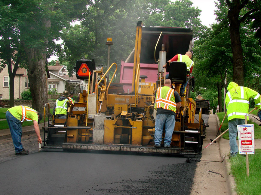 Photo of City staff milling and overlaying the road (resurfacing). 