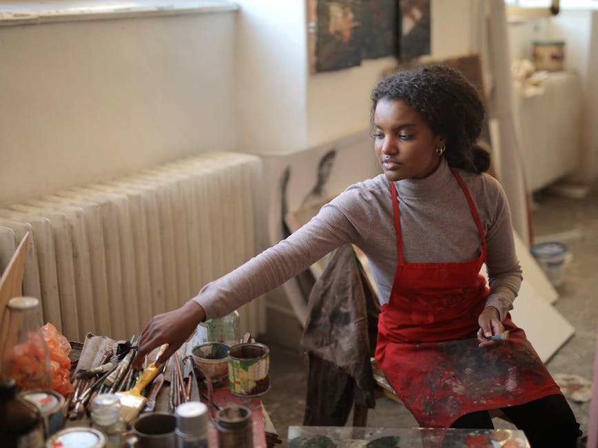 Young artist reaching for art supplies