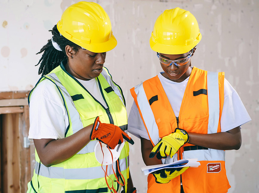 Two engineers review construction plans.