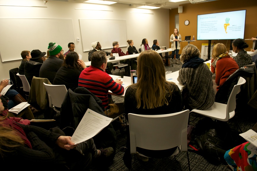 People in meeting listening to speaker