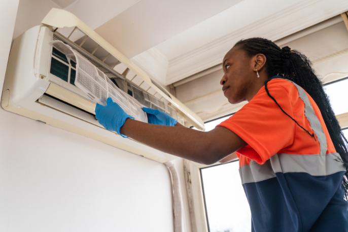 Person repairing home heating unit