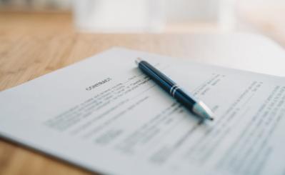 Pen resting on contract document
