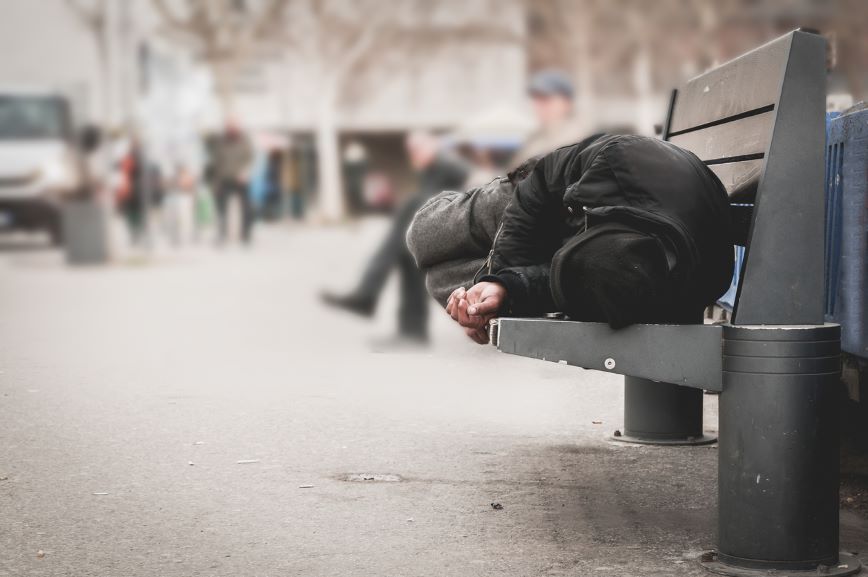 person on bench outside