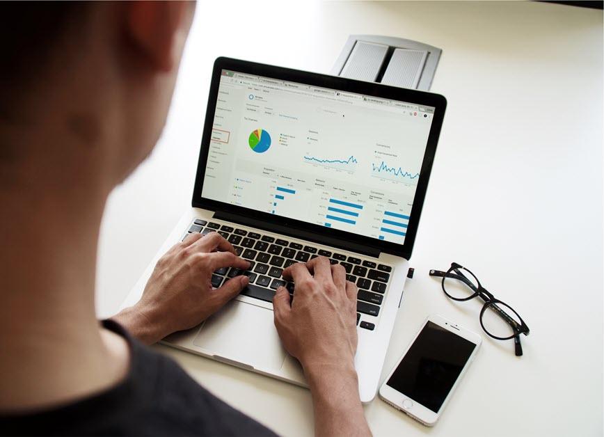 Person looking at reports on laptop