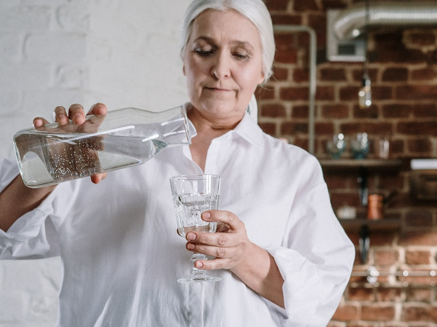 Person pouring glass of water