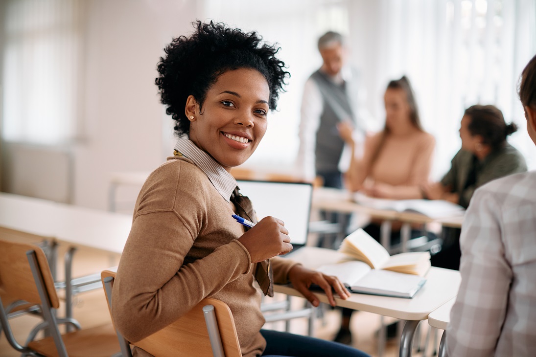 Smiling adult at desk