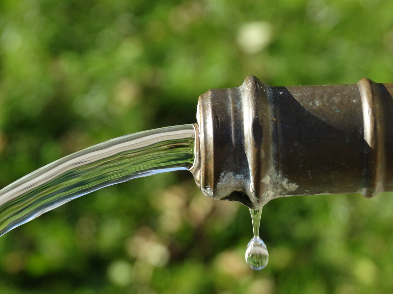 jet stream of water coming from faucet