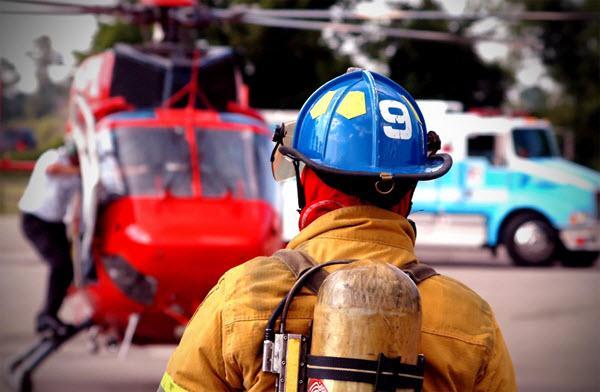 Firefighter watching medical evacuation helicopter Firefighter watching medical evacuation helicopter