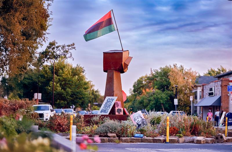 Wooden fist sculpture at George Floyd Square. Photo credit: Uche Iroegbu.