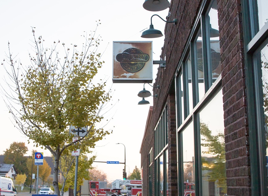 Lowry Avenue business with tree outside. Photo courtesy of Meet Minneapolis.