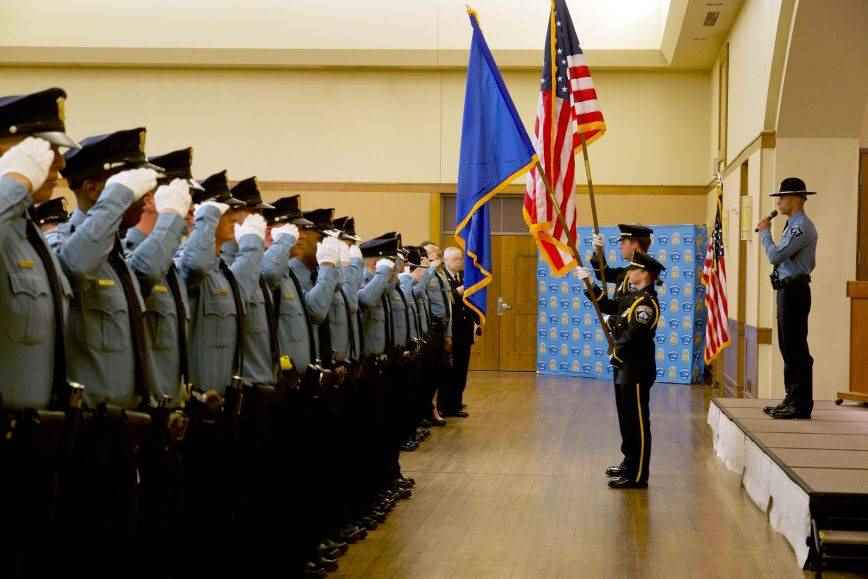 Minneapolis police recruits saluting flags