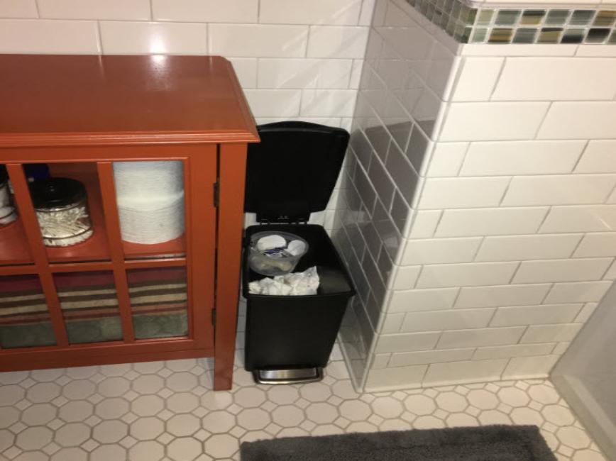 Bathroom wastebasket with separate smaller container clipped inside for compostables