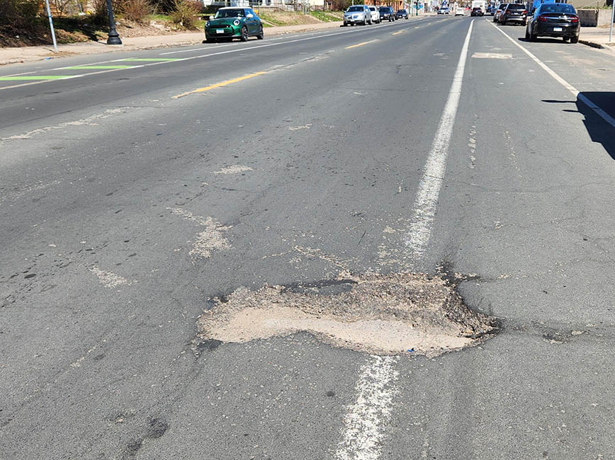 A large pothole in a road.