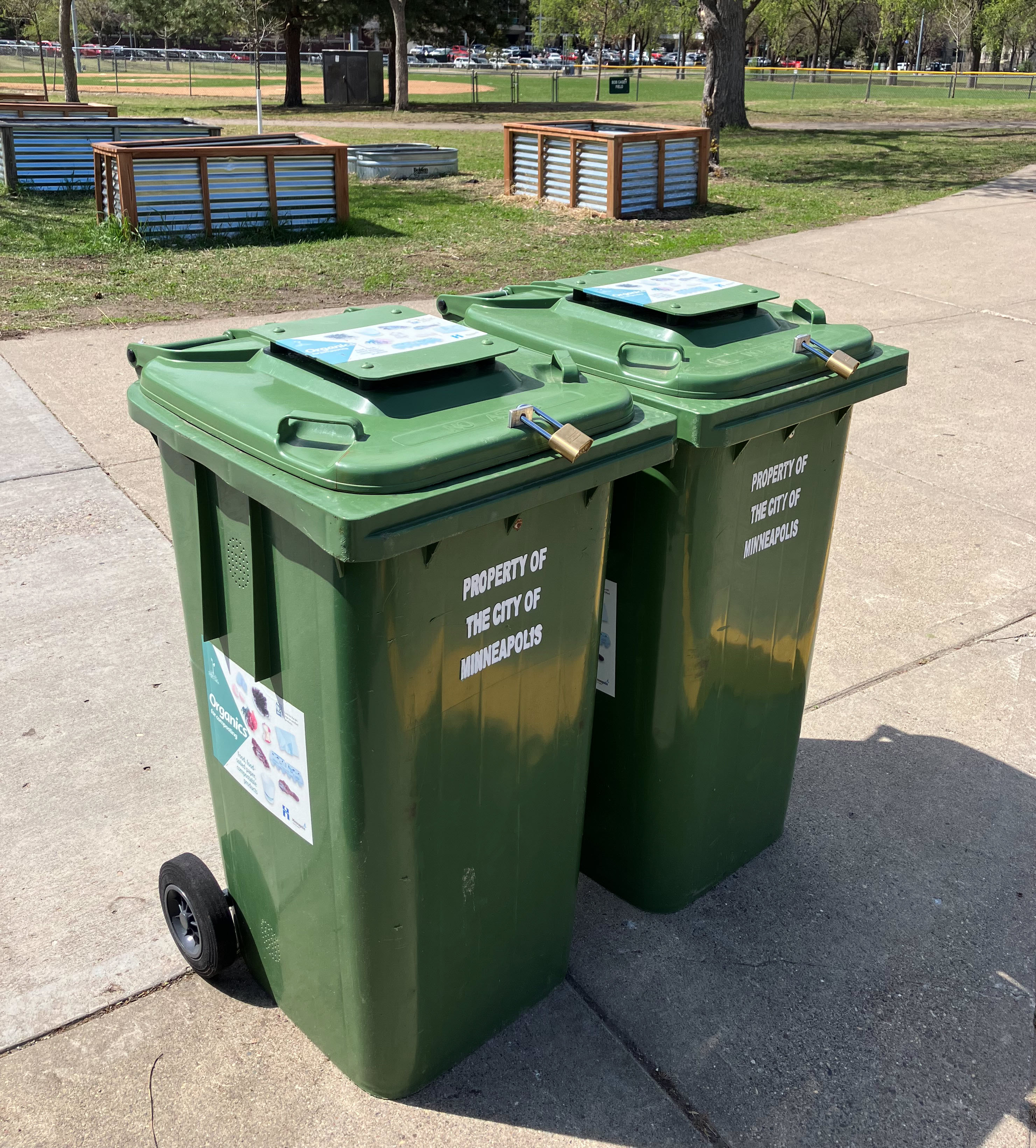 organics recycling carts at a drop-of site with 4 digit padlocks on them