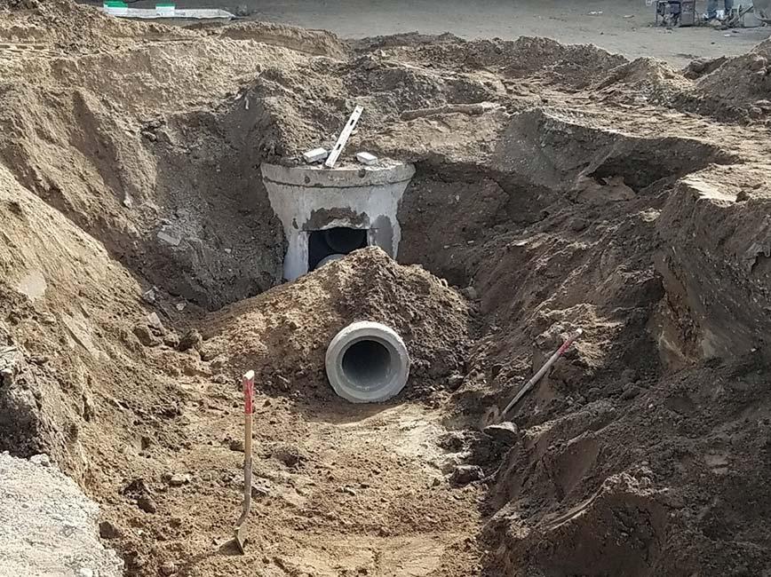 PW employees working on large pipe