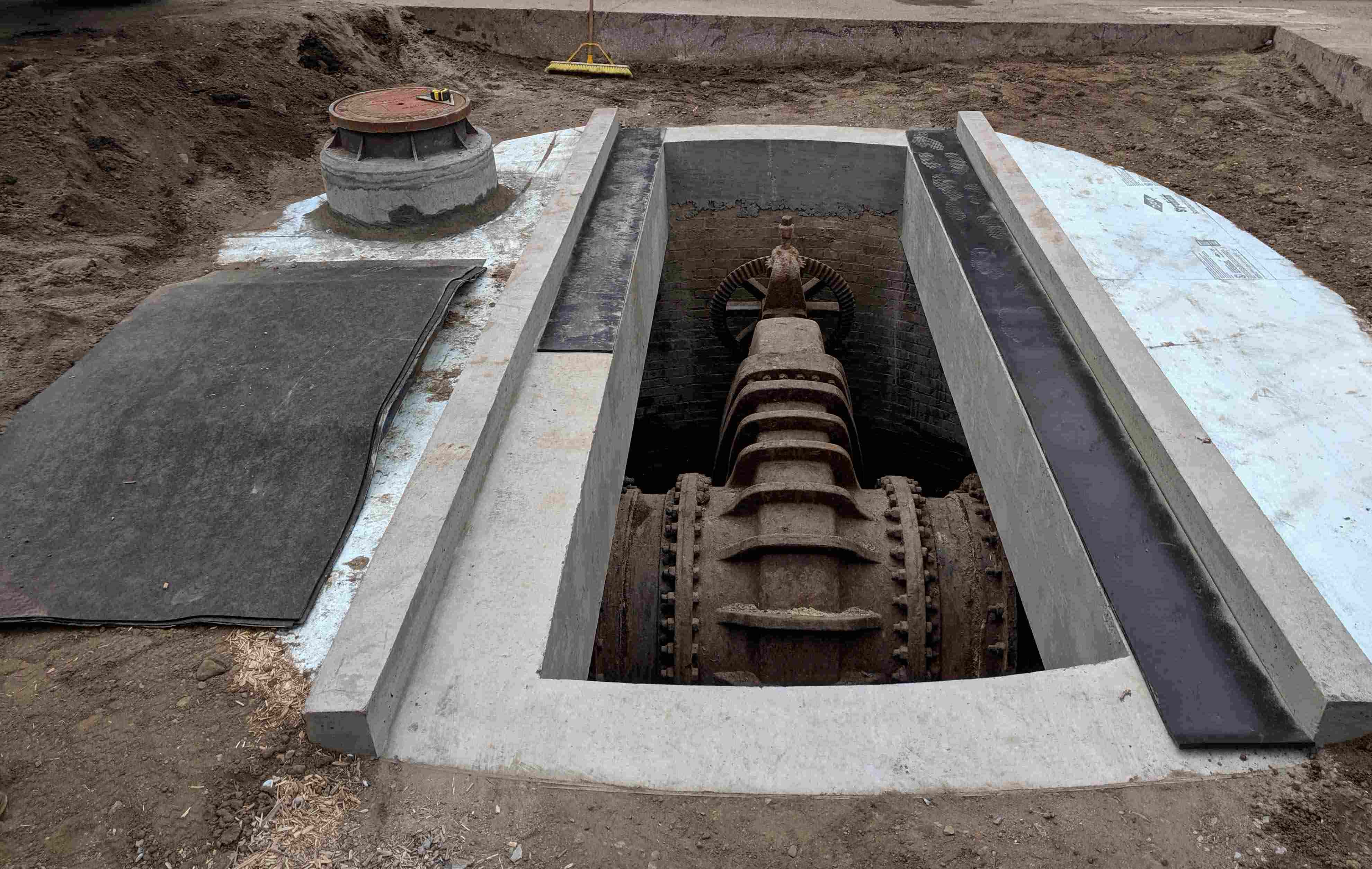Vault under the street containing a valve for a drinking water main. Vault under the street containing a valve for a drinking water main.