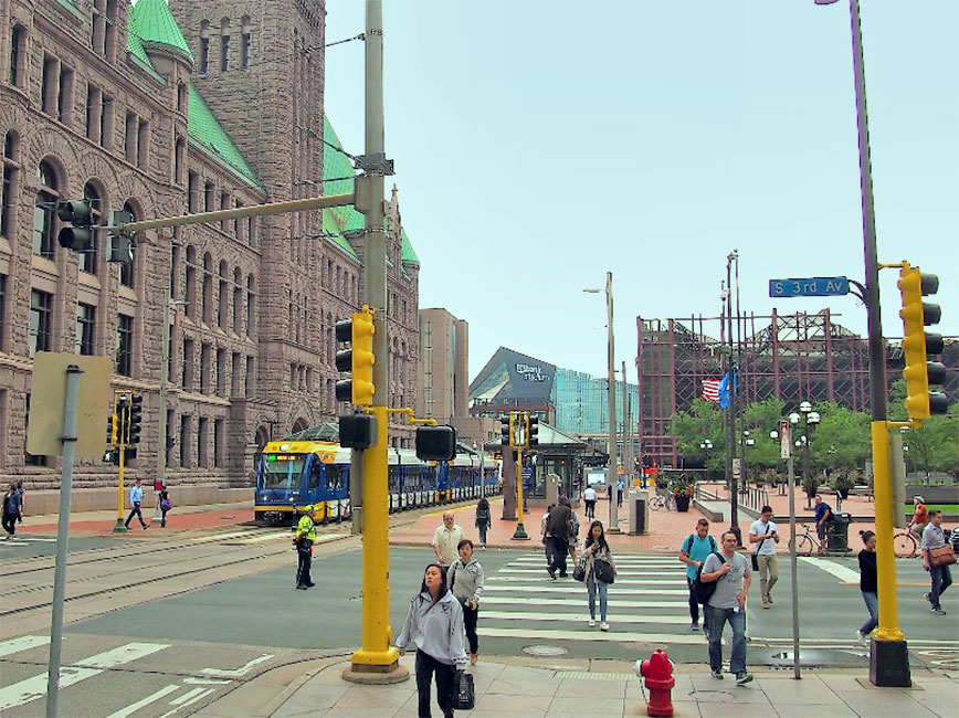 People walking downtown Minneapolis near the City Hall Building