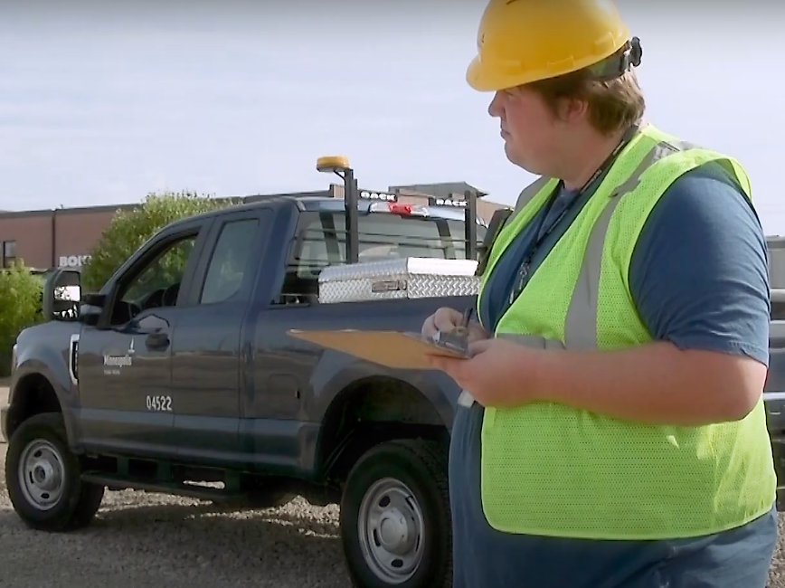 Intern taking notes by truck