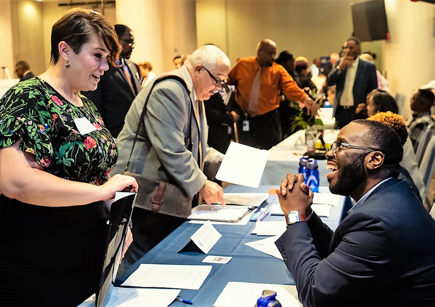 Person talking to employer at a job fair