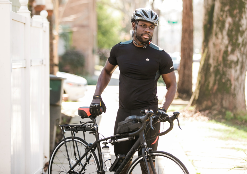 Man with helmet standing with bike