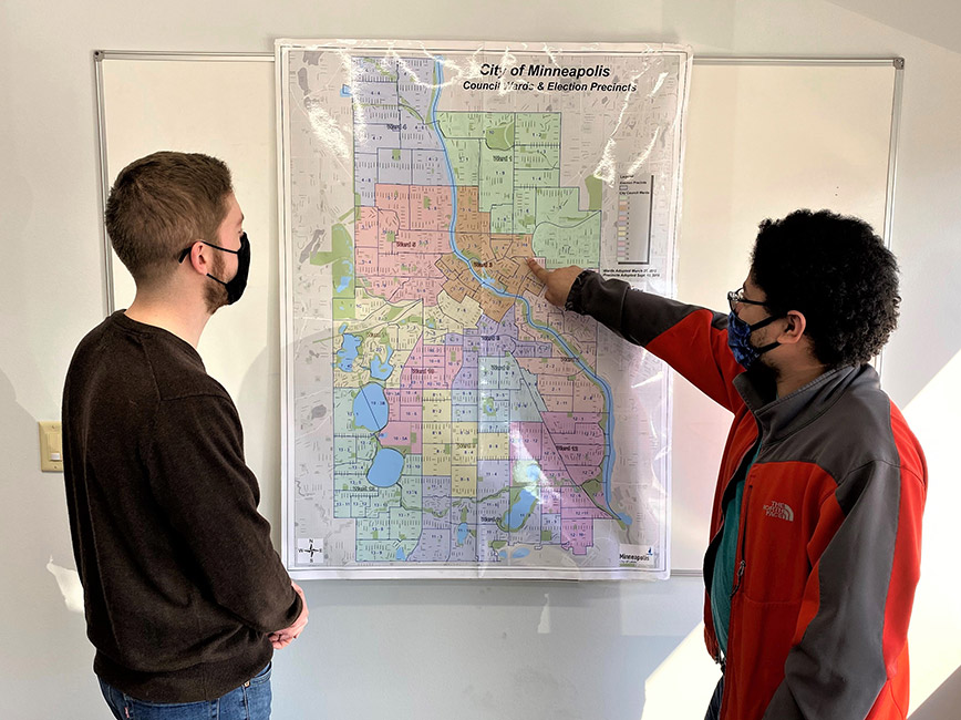Staff look at current map of council wards and voting precincts