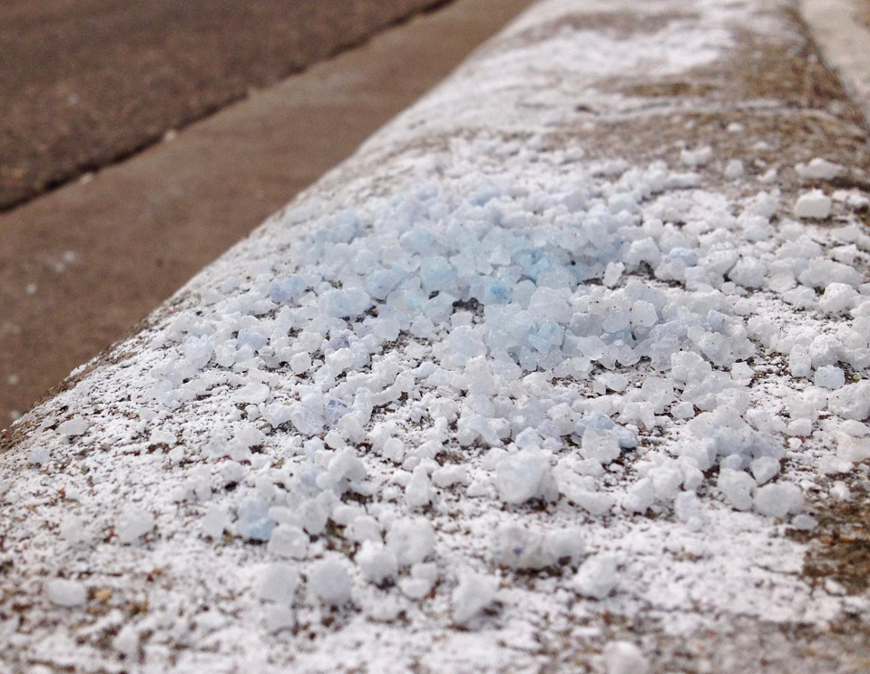 Pile of rock salt on sidewalk Pile of rock salt on sidewalk