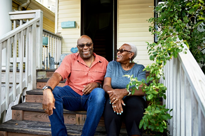 Two adults on front steps of house Two adults on front steps of house