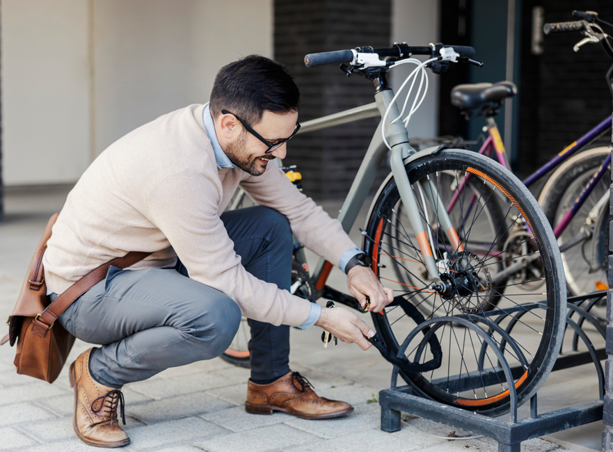 Person locking a parked bike