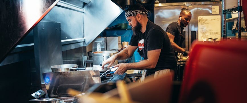 Two people working in restaurant kitchen Two people working in restaurant kitchen