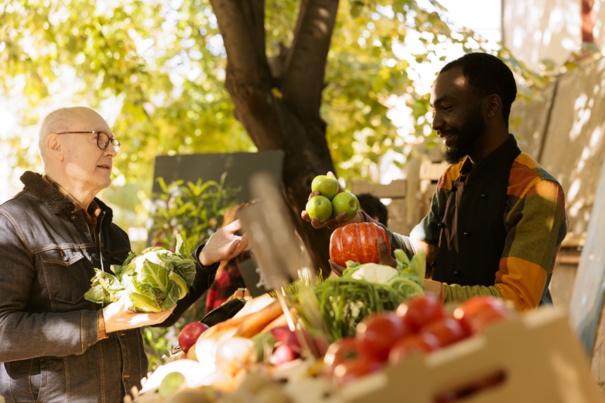 Farmers market vendor and customer talking Farmers market vendor and customer talking
