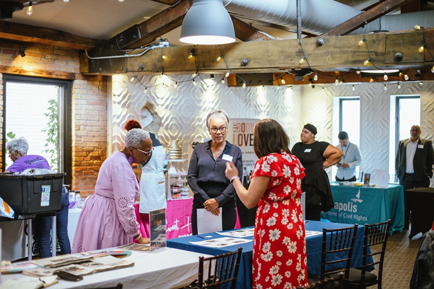 People standing around tables talking