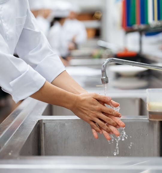 Restaurant worker washing hands Restaurant worker washing hands