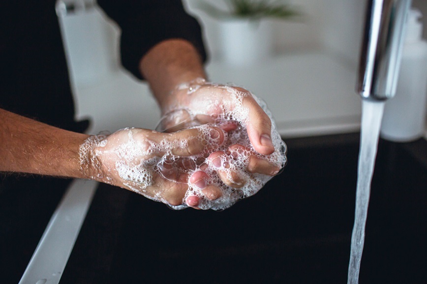 Restaurant worker washing hands in kitchen sink Restaurant worker washing hands in kitchen sink