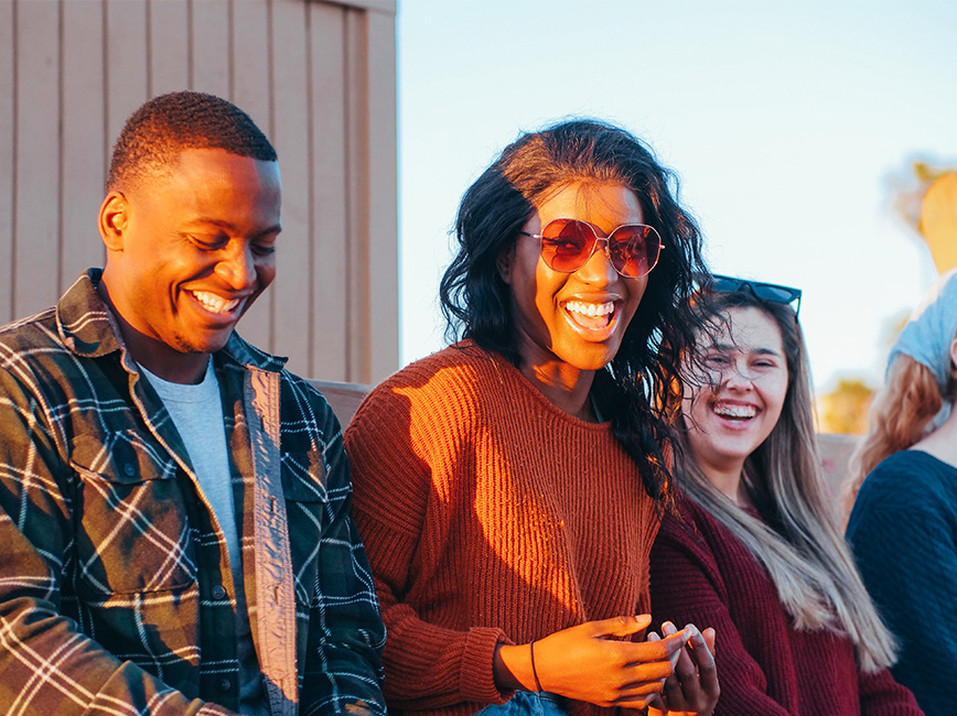 Three people smiling
