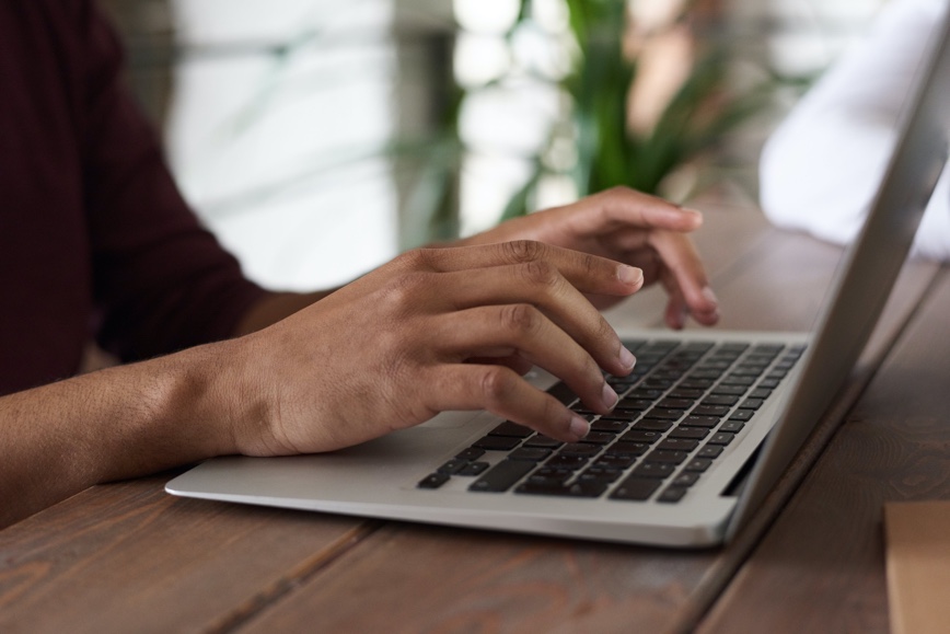 Hands on laptop keyboard Hands on laptop keyboard